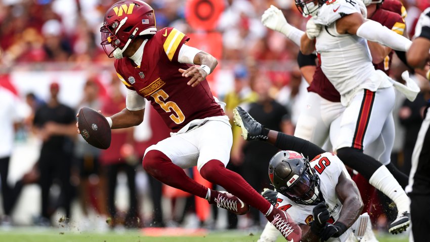 TAMPA, FL – SEPTEMBER 8: Jayden Daniels #5 of the Washington Commanders carries the ball during the fourth quarter of an NFL football game against the Tampa Bay Buccaneers at Raymond James Stadium on September 8, 2024 in Tampa, Florida. (Photo by Kevin Sabitus/Getty Images)